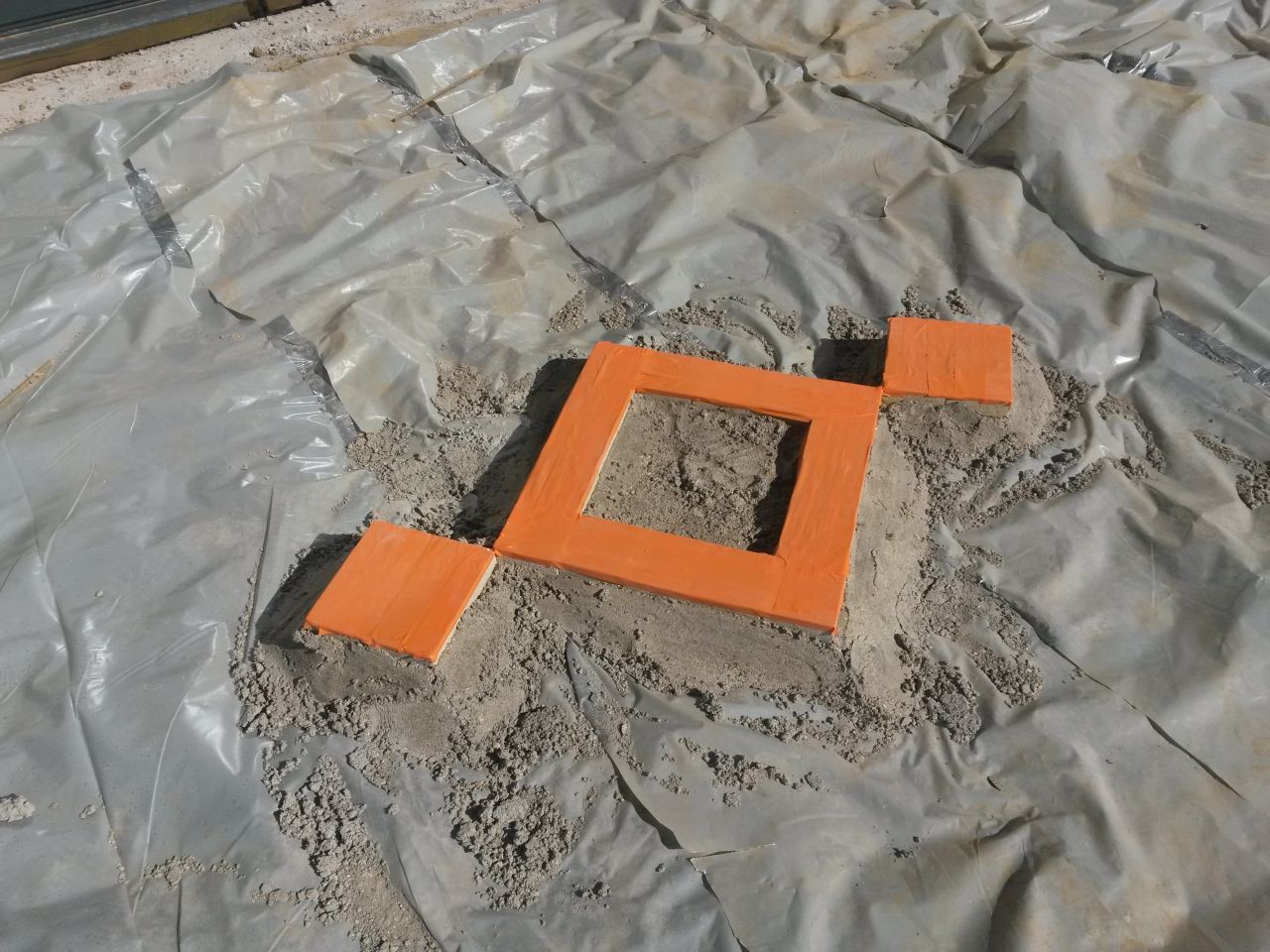 Terrasse en béton noir, motifs avec pavés de rue
<br />
Préparation pour le coulage, polyéthane, joints et protection des pavés.