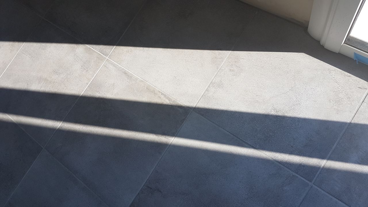 carrelage au sol de plus près. Les joints gris se fondent dans le carrelage
