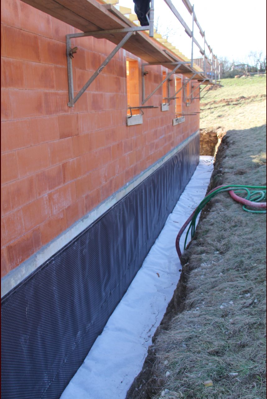 Drain et drainage (cailloux) en place sur les fondations et non tissé (bidim) au dessus