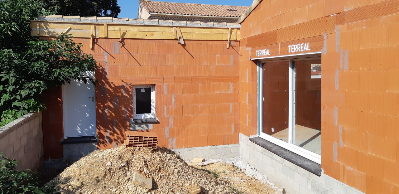Côté terrasse : la baie vitrée et la porte du garage