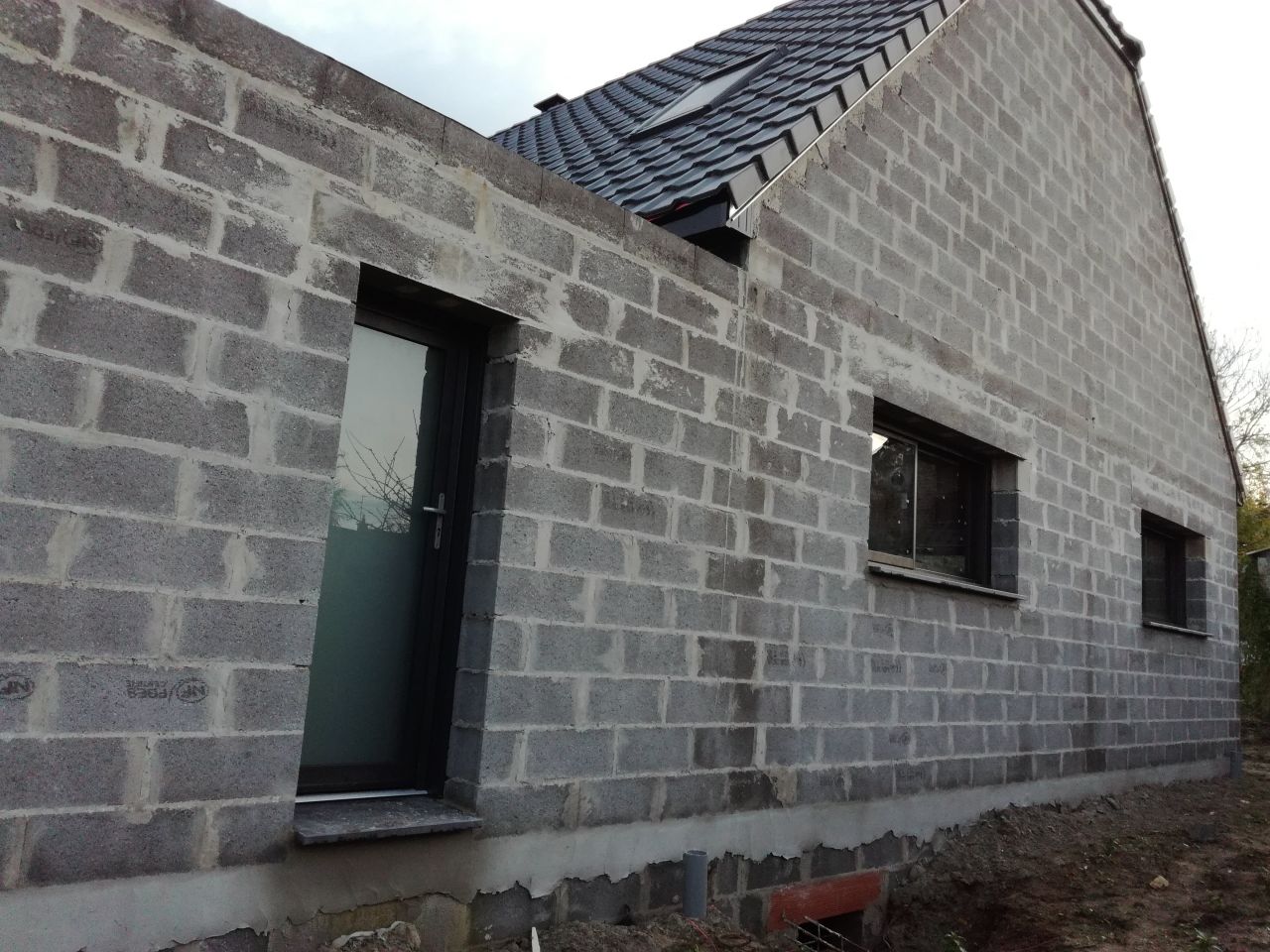 Facade sud : porte de service, fenêtre coulissante de cuisine et fenêtre fixe de salle à manger