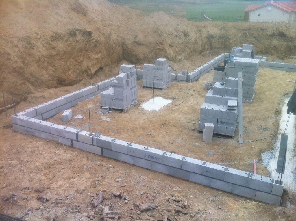 début du montage des parpaings du sous-sol. les deux rangs ajoutés pour l'augmentation du drainage et dalle.