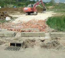 Remplissage des 40 cm de la plateforme décapée par des gros caillous pour faire un hérissonage sous la délle sous sol un drain et éiter de travailler dans la boue. Avec du recul cela ne s'avère pas une très bonne idée. En effet au moment de creuserles fondation les caillous tombainet au fond de la fouille. Cette étape est plutot à réaliser après le coulage des fondations à mon avis. Enfin je le saurais pour la prochiane fois :)