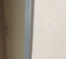 Pose des baguettes de finition dans les angles des murs peinture/papier peint