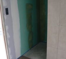 Le carrelage du sol s'arr&ecirc;te &agrave; l'entr&eacute;e de la douche, il y aura des galets au sol