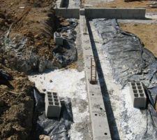 Premiers parpaings du vide sanitaire. Au centre, l'ancienne citerne, désormais comblée au gros béton.