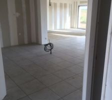 Pièce à vivre vue de l'entrée. Au fond, nous allons installer du parquet.
