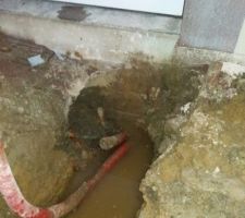 Vidage du vide sanitaire et raccordement du drain et des gouttiere au reseau communal