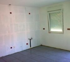 Carrelage au sol termin&eacute; du c&ocirc;t&eacute; cuisine, avec les joints mais sans les plinthes, carreaux de 40 x 40 cm, coloris gris.