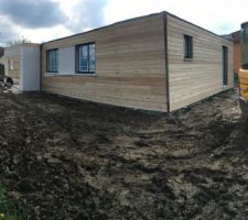 Maison vue côté chambre. Les espaces blancs seront enduits en gris anthracite. Bardage en mélèze traité mais nature