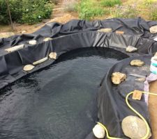 Après la pose de la membrane, remplissage à l'eau de pluie, avec une partie d'eau potable.