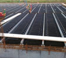 Fondation par semelles filantes en b&eacute;ton arm&eacute; dos&eacute; &agrave; 350kg. Armatures semelles type longrines compos&eacute;es de cadres 15/35 et de 6 aciers filants. Disposition visant &agrave; limiter le tassement diff&eacute;rentiel ainsi que les micro-fissurations en superstructure. Construction r&eacute;alis&eacute;e suivant les normes parasismiques en vigueur.