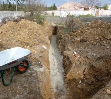 Tranchées eaux usées. Une couche de sable avant la pose des PVC