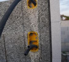 Un exemple,à la porte d'entrée. Le double interrupteur  et en haut l'arrivée de l'interphone. On le voit tout passe dans le centre du bloc bois ciment ou sera injecté le béton.