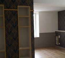 Vue vers le coin chambre et sa tête de lit.