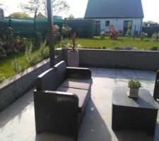 Terrasse terminée avec son petit salon de jardin, sa pergola bioclimatique et ses plantes.