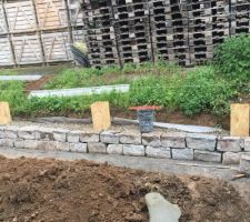 Pose Des premières pierres granit pour montage du mur en pierre sèche