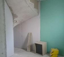 Sous l'escalier, côté salle de bains du bas. On a demandé à ce que le placo ne descende pas jusqu'en bas, ça nous fera une espèce de niche pour du rangement supplémentaire