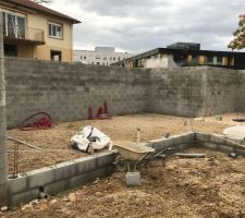 Les murs en blocs à bancher n'ont plus qu'à être remplis de béton, le hérisson est terminé et la pose du TMS est en cours