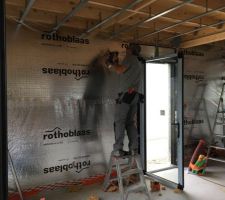 Traversée murale en cours de pose par l'électricien