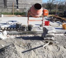 Préparation du coulage du surbot, par temps frais (8°c), à la bétonnière. Comme pour la dalle, il est dosé en ciment à 350kg/m3, étant donné que les murs en bois viendront se fixer directement dedans.
L'eau de gâchage est prise dans la douche pour avoir une eau à environ 20°c, on met un sachet d'accélérateur de prise par gâchée (un sac de 35kg de ciment par gâchée) afin d'être certain que la prise soit faite avant le retour du froid et du gel imminent.