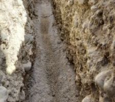 Lit de sable pour maintient de la pente, et trou qui recevra le tuyau pour relier le drain. Ce sera un tuyau PVC CR8 Ø110m, qui s'emboite parfaitement dans le drain. Pas besoin de drain à cet endroit et cette profondeur.