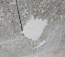 Trou de maçonnerie rebouché à l'enduit de façade