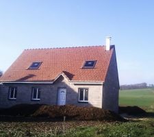 Photo de la maison avec ca cheminé et le beau temps du jour.