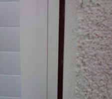 Environ 1 cm et au fond on peut voir du bois?? le crépi devrait arriver sur la baguette blanche...