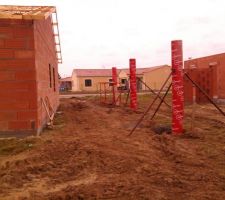 Les poteaux qui soutiendront la panne de l'abri voiture entre chez nous et le futur voisin.on est en limite de terrain.