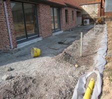 "pose du drain à l'arrière de la terrasse derrière la maison