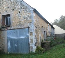 Séjour au rdz de chaussée derrière porte métallique, fenêtre chambre parentale à l'étage