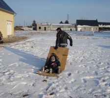 Lylou qui fait de la luge sur un malheureux bout de carton hi hi hi !!! AVEC  le fils de ma meilleur amie sur notre terrain enfin ce qu il en parait pour le moment mdr