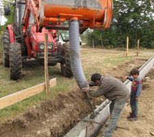 Après avoir mis en place les tuyaux et gaines pour les évacuations, arrivée d'eau, électricité et PTT. On coule le béton dans les blocs à bancher.