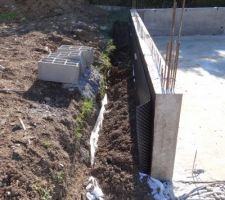 Drain recouvert contre le nord mur du garage