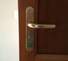 La poignée de porte d'entrée installée à la livraison de la maison.
A mon avis, il y a un gros problème de positionnement de la poignée (non centrée sur la menuiserie - Menusier "Gregoire")