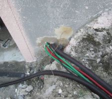 Les gaines sont passées dans les tranchées et scellées via le mur du sous-sol vers le tableau électrique.