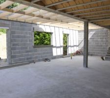 Vue depuis le salon (de gauche à droite) : la salle à manger, la cuisine, l'arrière-cuisine et au pied des marches la cave. Les marches mènent au garage.