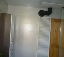 R&eacute;novation salle de bains termin&eacute;e: vue du s&egrave;che-serviettes et du conduit du po&ecirc;le &agrave; bois