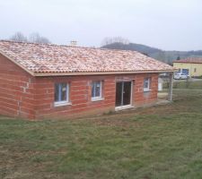 La maison est prise de l'arrière; le chemin d'accès se trouve de l'autre coté