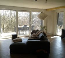 Le séjour. Au sol un carrelage effet parquet. Menuiseries PVC blanches