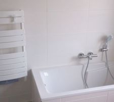 Baignoire et sèche serviettes soufflant dans la grande salle de bain